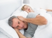 Man sleeping next to a snoring woman